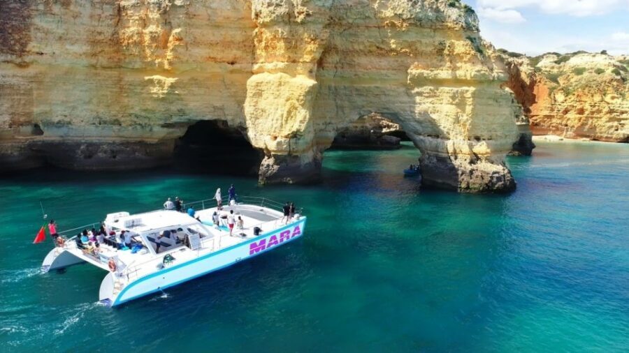 Albufeira: Catamaran Cruise with BBQ & Open Bar on the Beach - The dinghy hop to the nearest caves: close access, wet shoes, and sea-state reality
